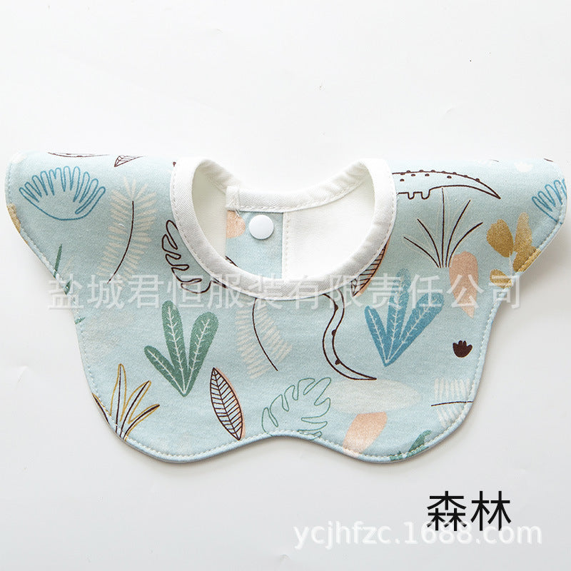 Baby bib with leaf pattern on a light blue background