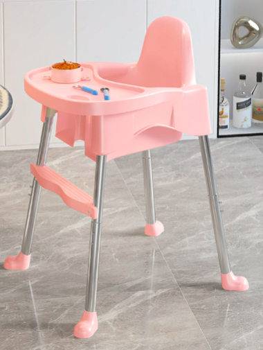 Pink baby high chair with tray on a tiled floor