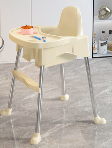 Beige baby high chair with tray on a gray floor