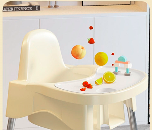 Children's high chair with a small table and toy on a light gray background