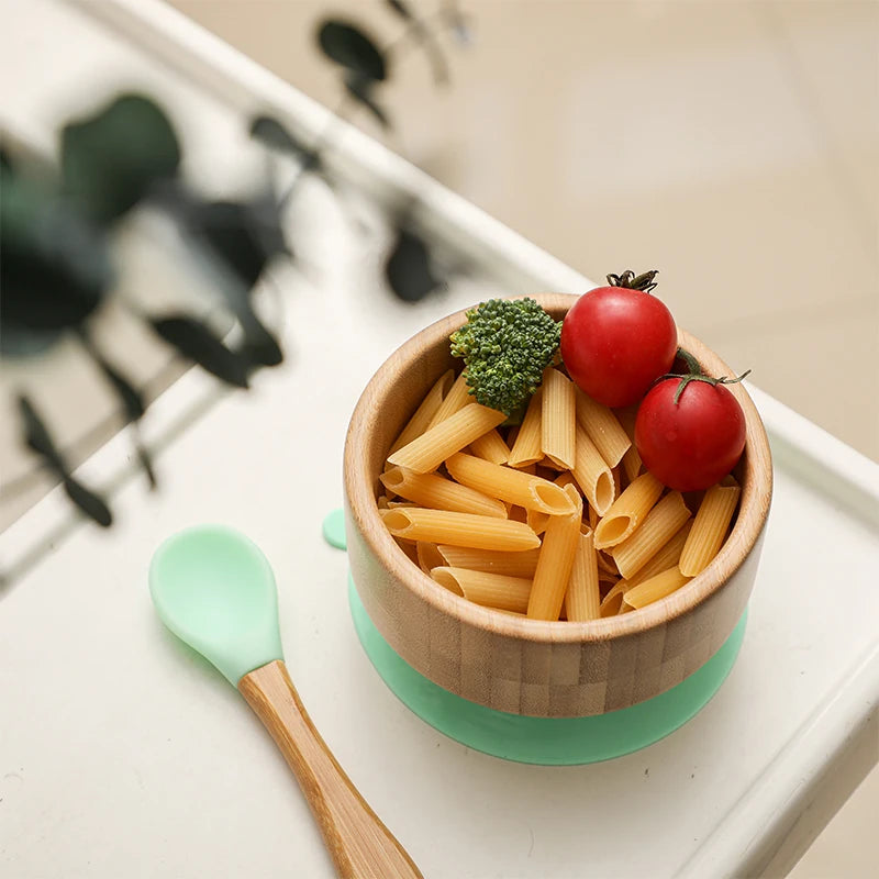 Wooden bowl with pasta and vegetables on a white tray