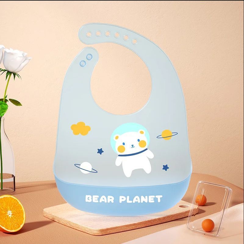 Children's bib with bear design and 'Bear Planet' text on a beige background