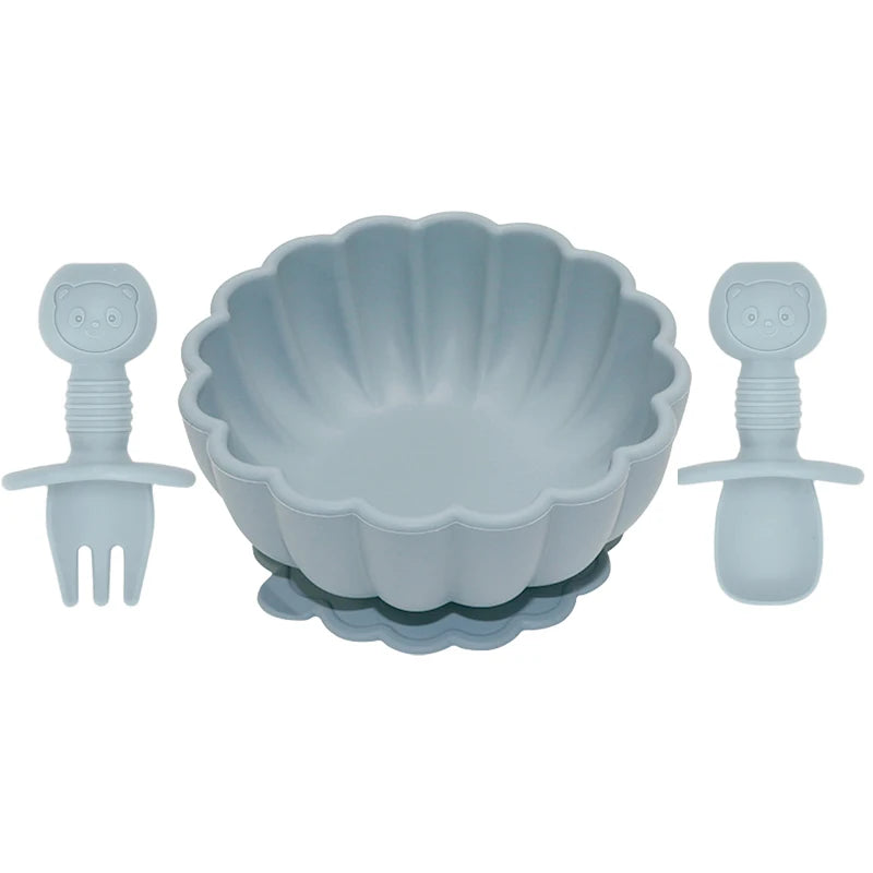 Set of blue children's bowl and utensils on a white background