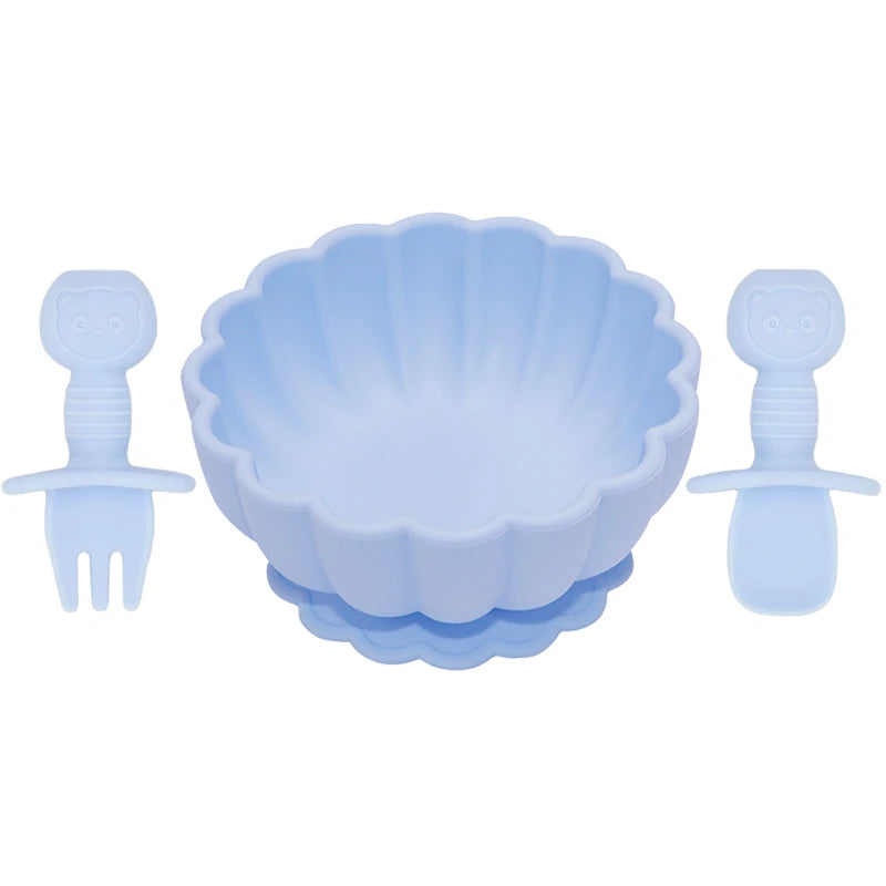 Set of blue baby utensils including a bowl, fork, and spoon on a white background