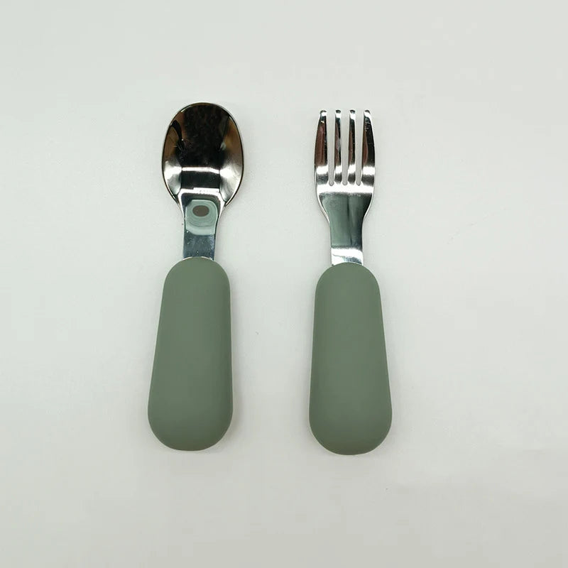Spoon and fork set with green handles on a white background