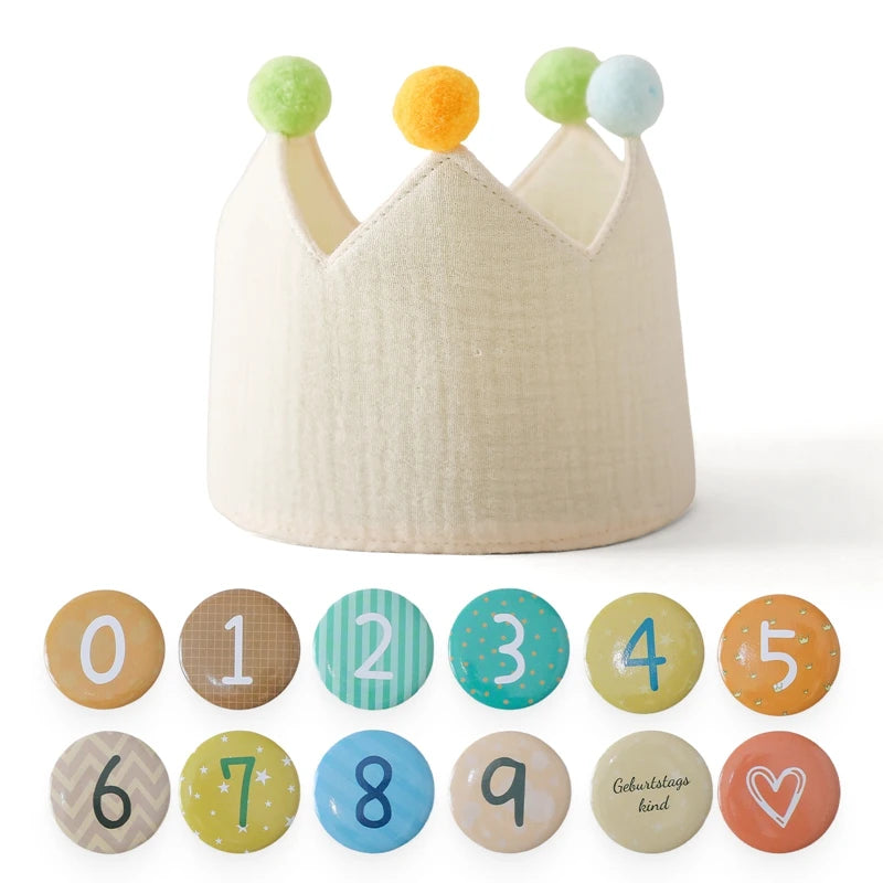 Children's crown with colorful pom-poms and number badges on a white background