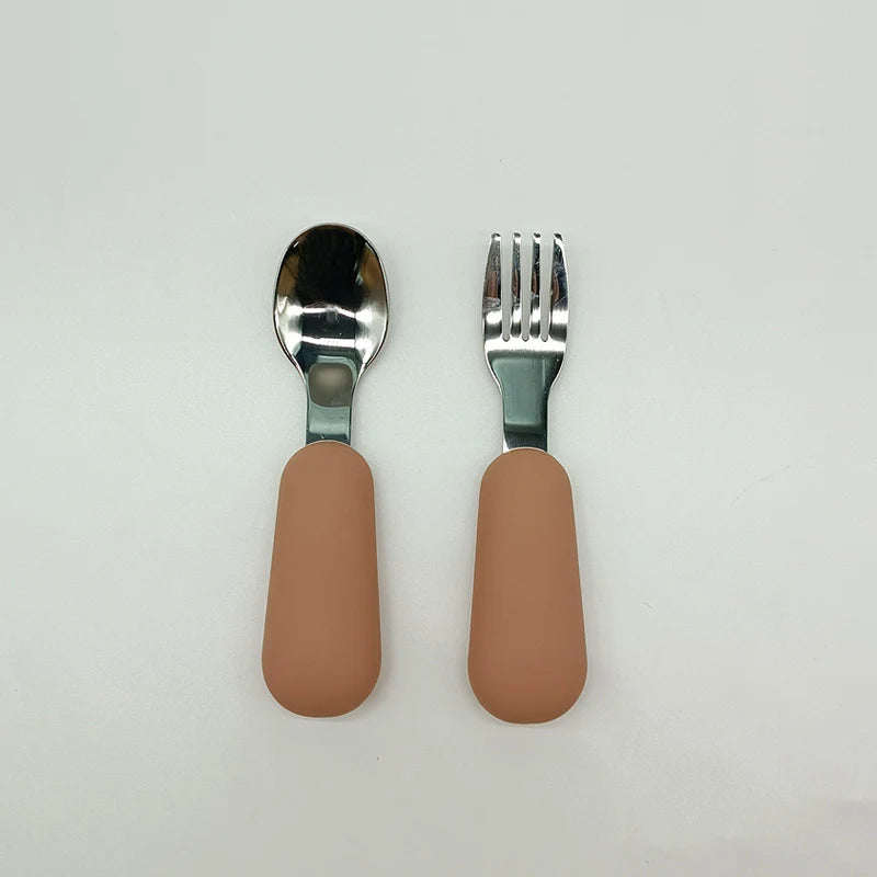 Spoon and fork set with brown handles on a light gray background