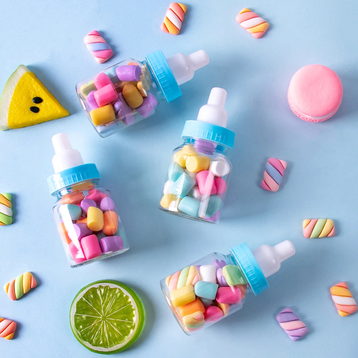 Colorful candy in glass bottles on a blue background with fruit slices.