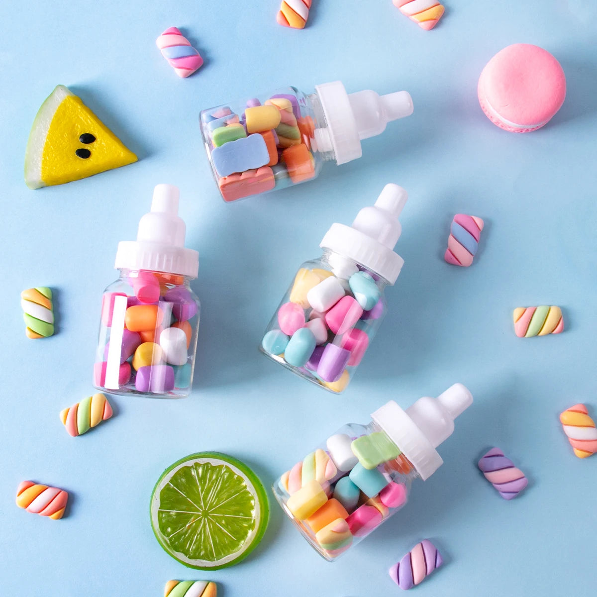 Colorful candy bottles on a blue background with candy decorations