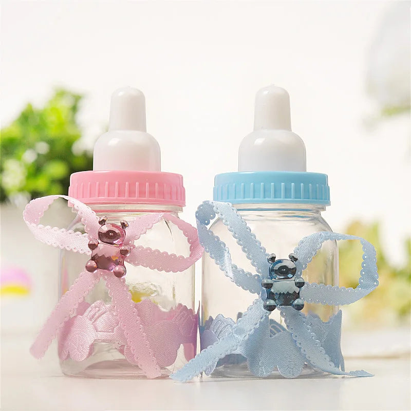Two decorative bottles with pink and blue lids, each featuring a small figurine inside, on a blurred background.