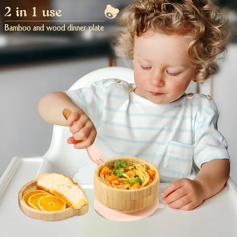 Child using a bamboo and wood dinner plate with food and a spoon.