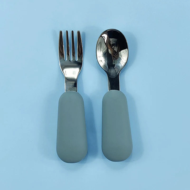 Silver fork and spoon with light blue handles on a light blue background