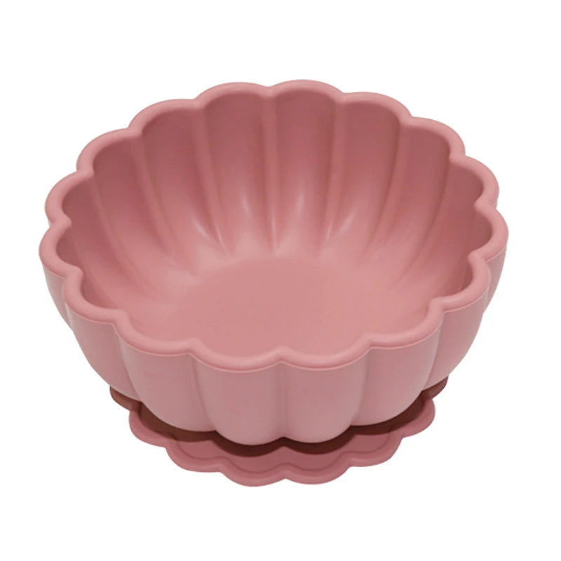 Pink fluted baking dish on a white background