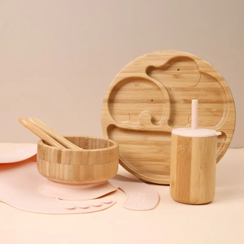 Bamboo tableware set including a bowl, cup, and tray on a beige background