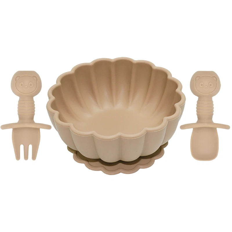 Beige bowl with matching fork and spoon on a white background