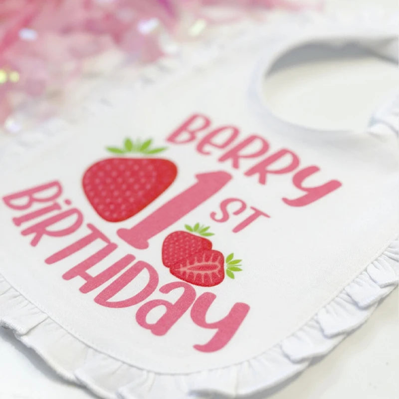 Baby onesie with 'Berry 1st Birthday' text and strawberry graphics on a white background.