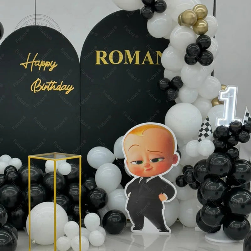 Birthday celebration setup with balloons, a cutout of a character, and personalized signs.