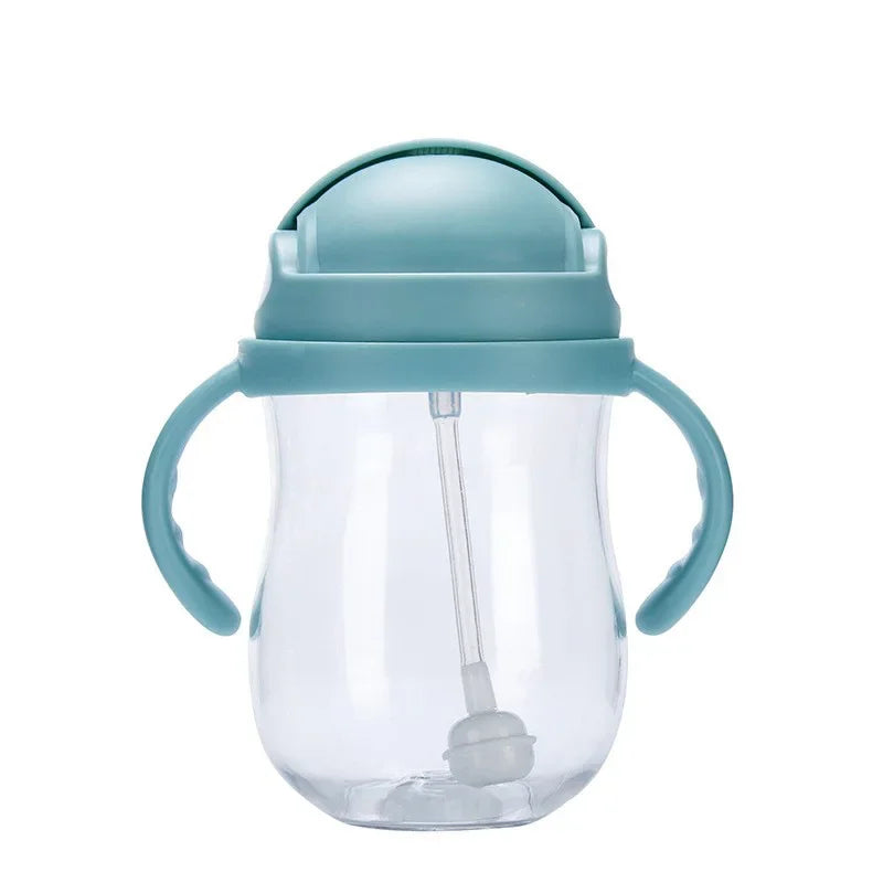 Clear sippy cup with blue handle and lid on a white background