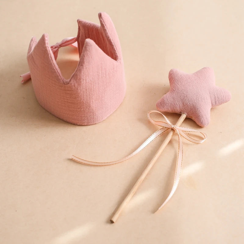 Pink crown and wand set on a beige background