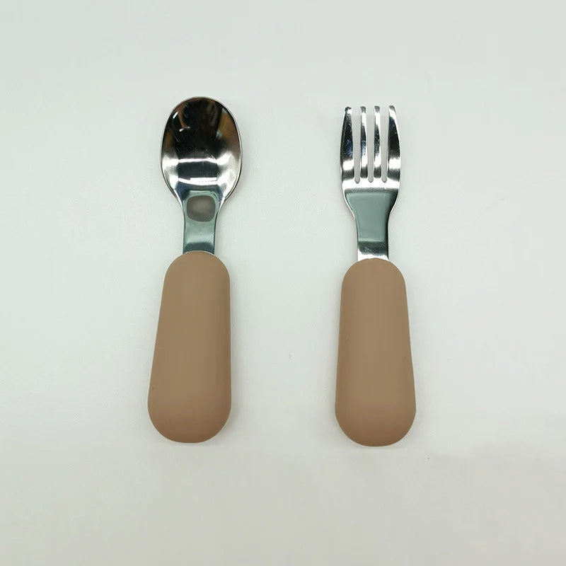 Spoon and fork set with beige handles on a white background
