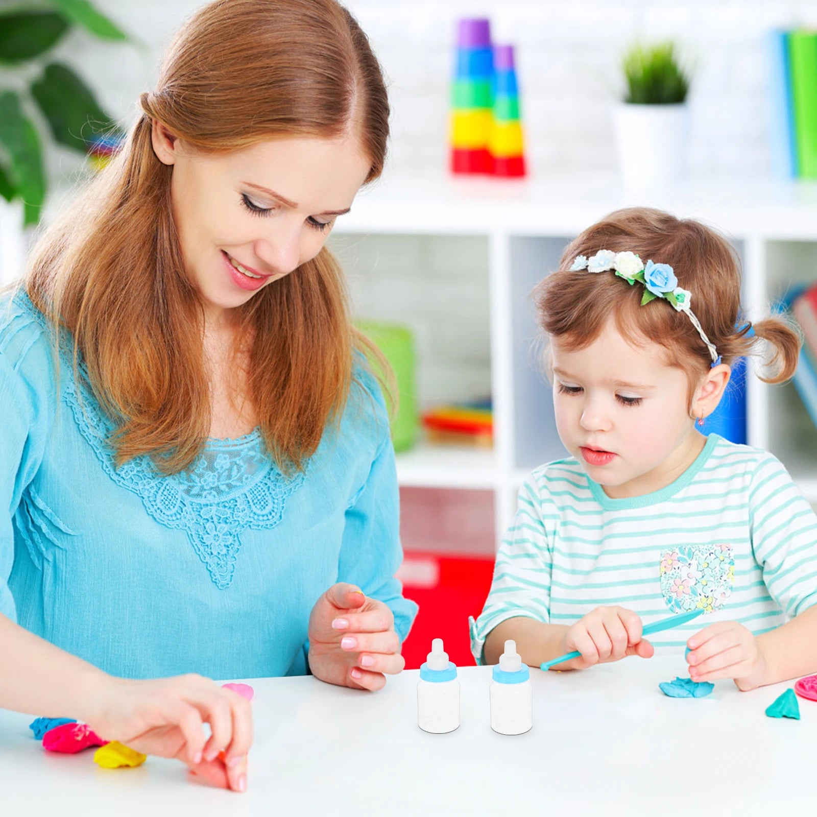 Woman and young child playing with colorful toys in a bright room