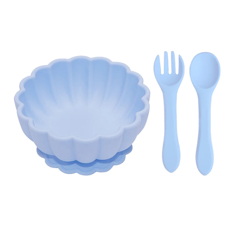 Set of blue children's bowl, fork, and spoon on a white background