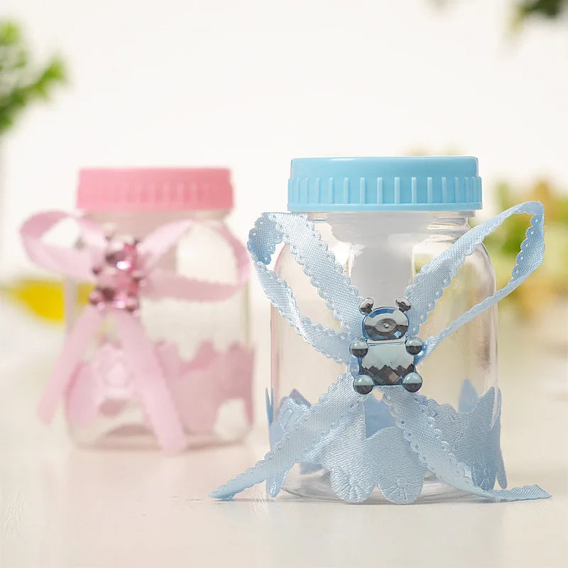 Clear jar with blue lid and decorative ribbon, pink container in the background