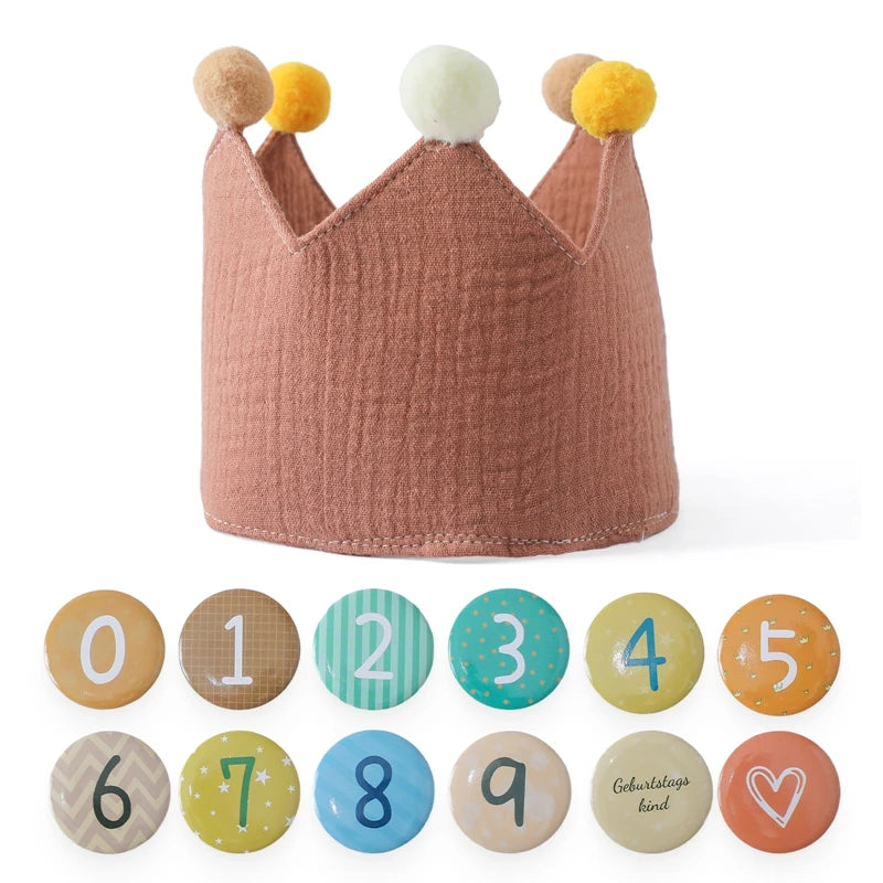 Children's crown with pom-pom decorations and number stickers on a white background