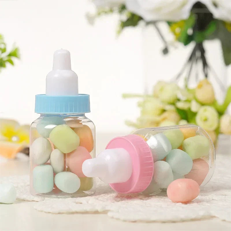 Two baby bottle-shaped containers filled with colorful candies on a light background.