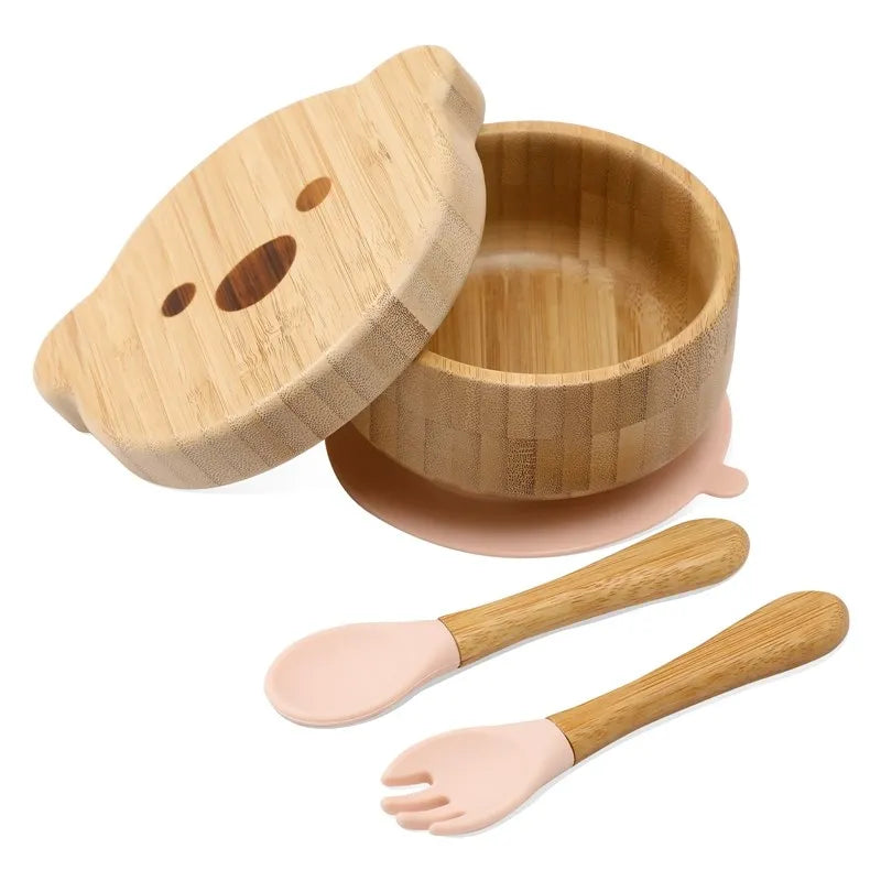 Bamboo baby bowl with lid, spoon, and fork set on a white background
