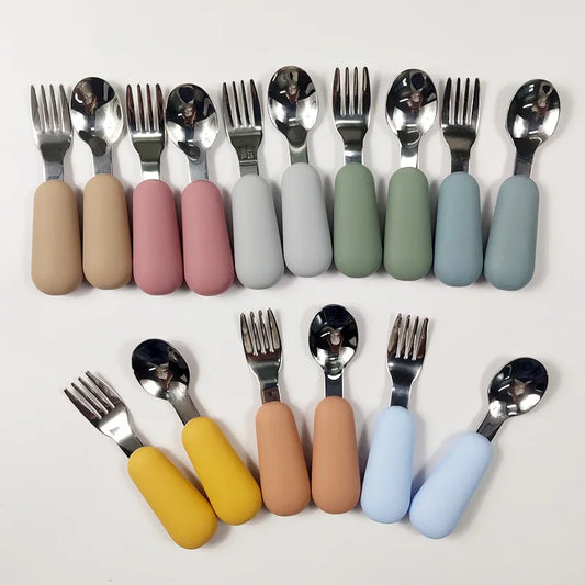 Set of silver cutlery with colorful handles on a white background