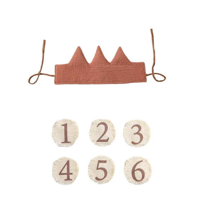 Coral-colored baby crown with numbers 1 to 6 on a white background