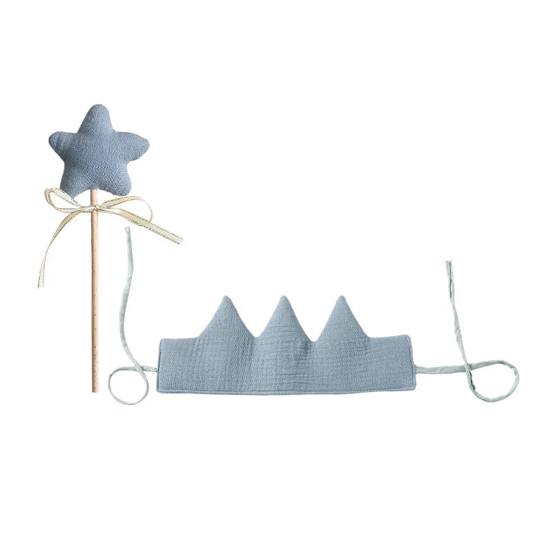 Blue star-shaped toy and crown on a white background