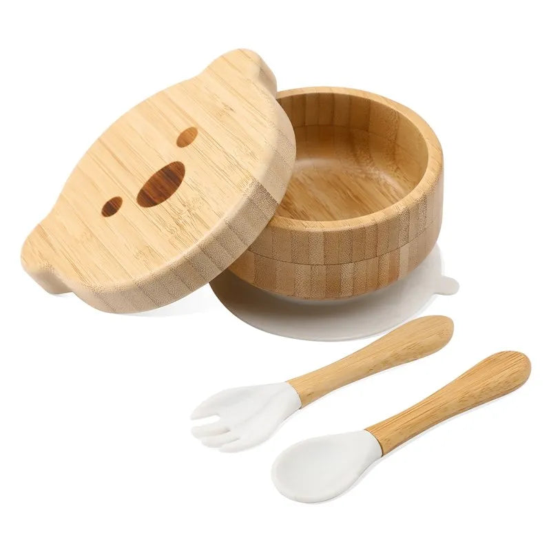 Wooden bowl with lid, spoon, and fork set on a white background