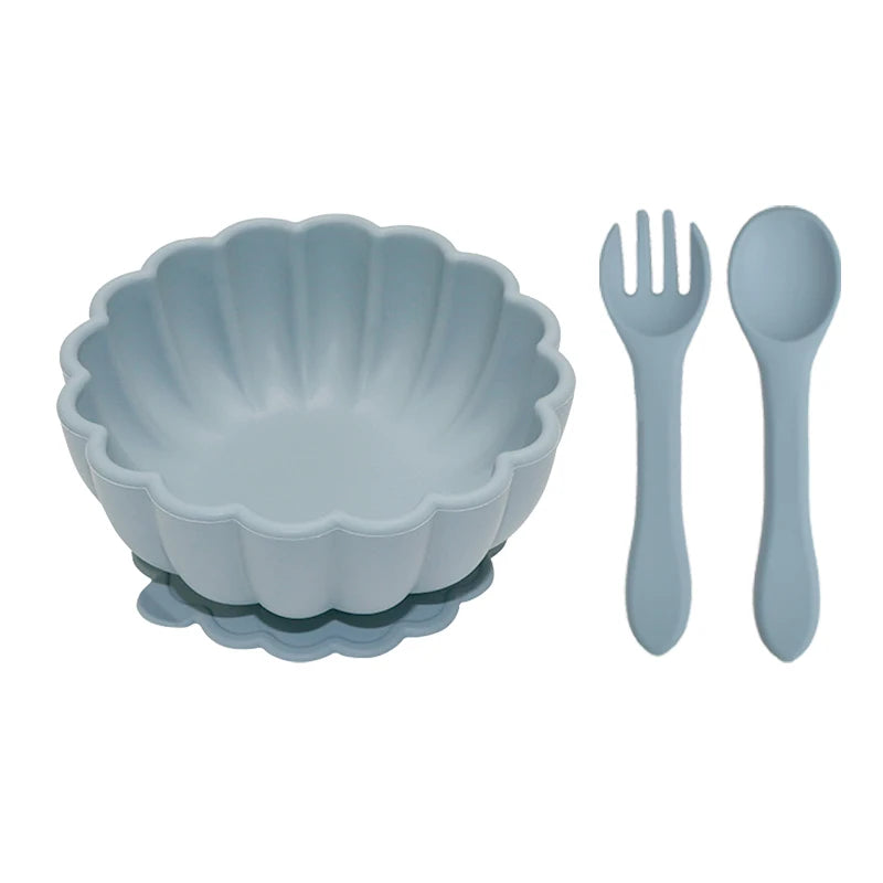 Set of blue bowl, fork, and spoon on a white background