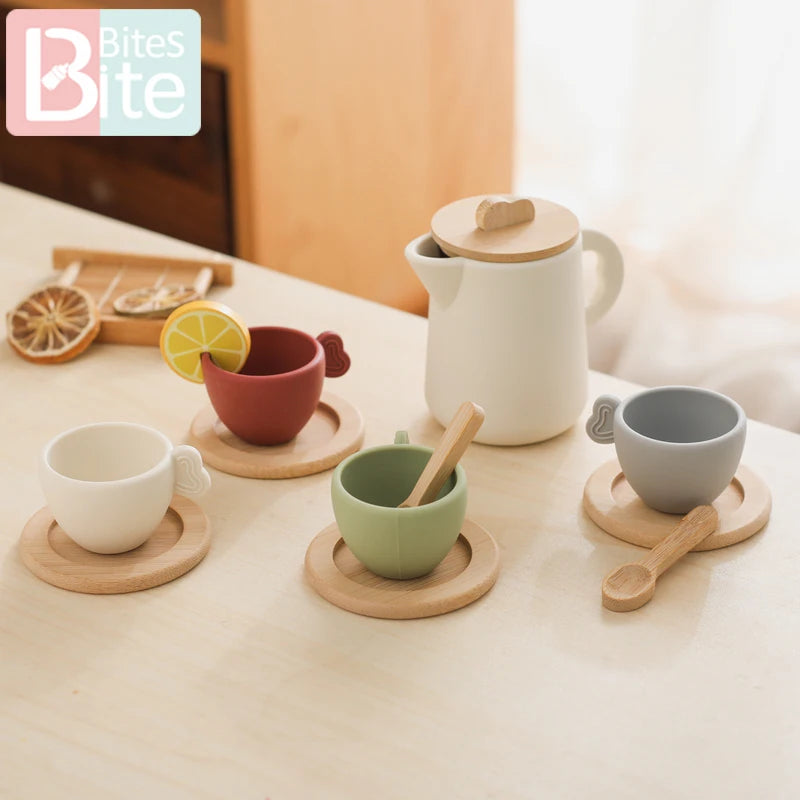 Set of ceramic cups and a teapot on a table with 'Bites' branding.