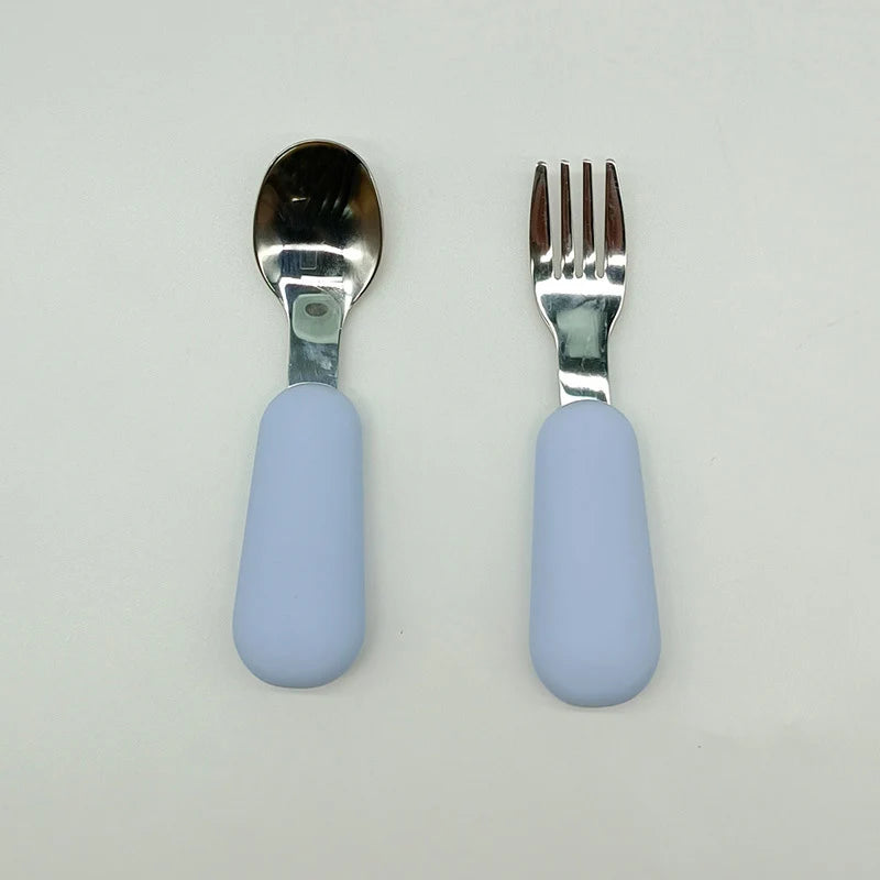 Spoon and fork set with light blue handles on a white background