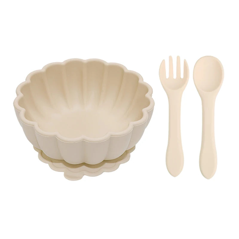 Beige ceramic bowl with matching fork and spoon on a white background