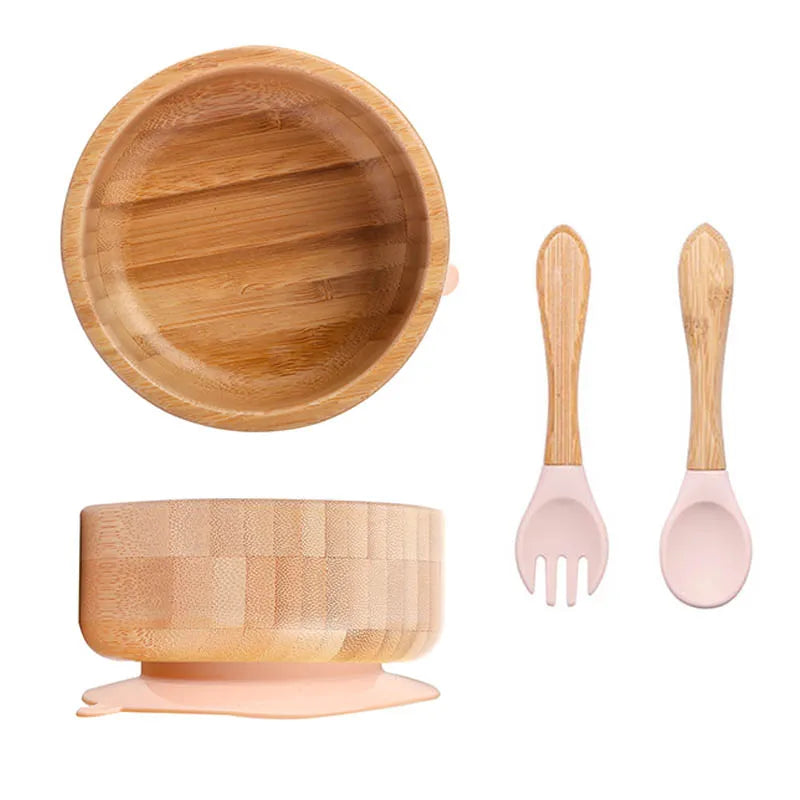 Bamboo bowl set with pink fork and spoon on a white background