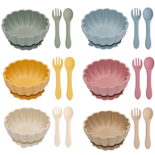Set of colorful bowls and cutlery on a white background