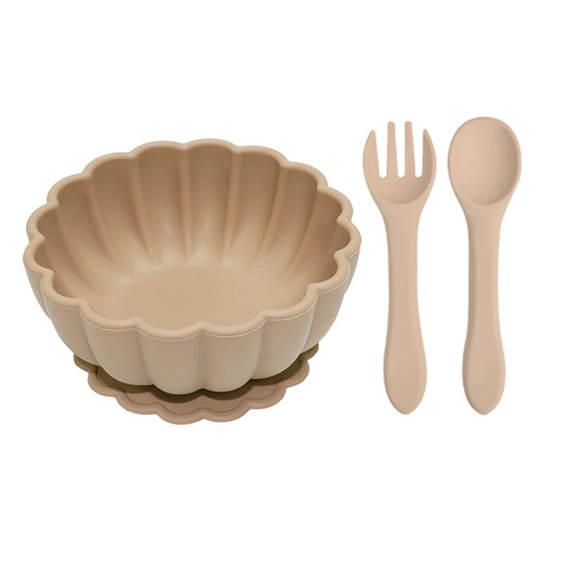 Beige bowl with fork and spoon on a white background