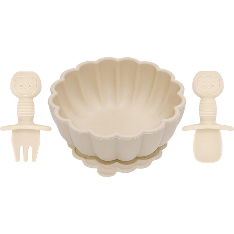 Set of beige bowl, spoon, and fork on a white background