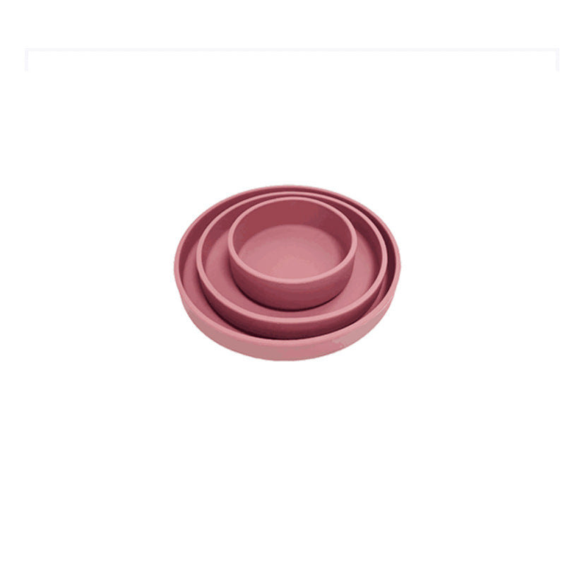 Set of three pink bowls of different sizes on a white background