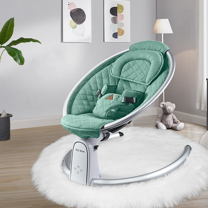 Green baby swing chair in a room with a teddy bear and plant decor.
