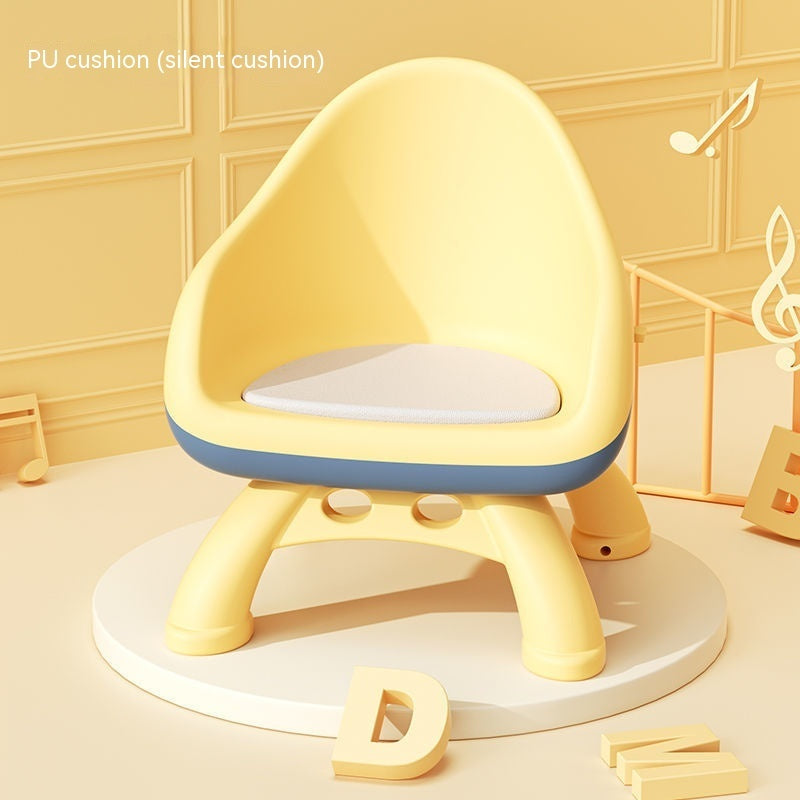 Yellow children's chair with a cushion on a light yellow background