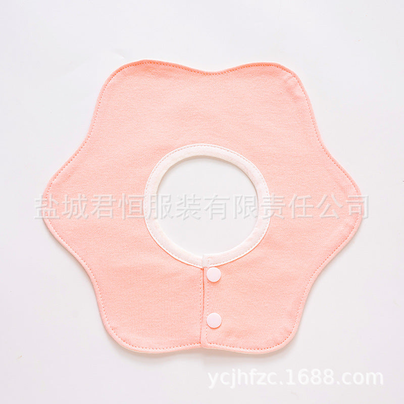 Pink fabric collar with white buttons on a light gray background