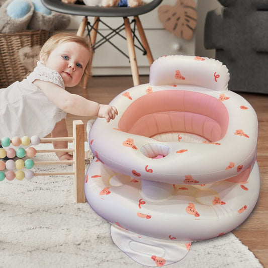 Baby playing with a pink and white inflatable seat in a room with toys and furniture.