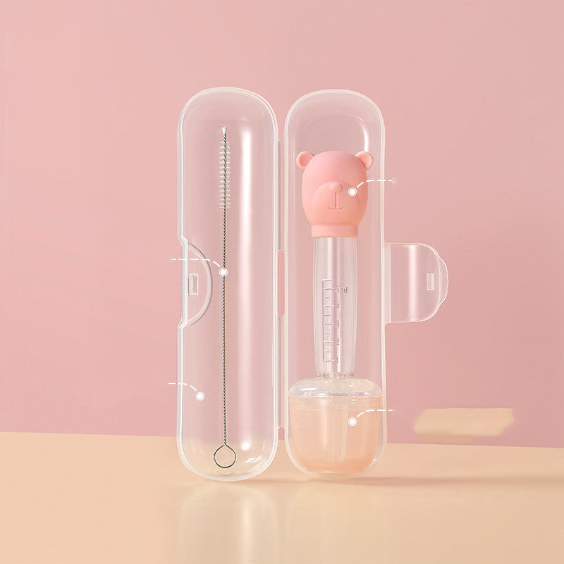Pink baby bottle with bear design in a clear case on a pink background