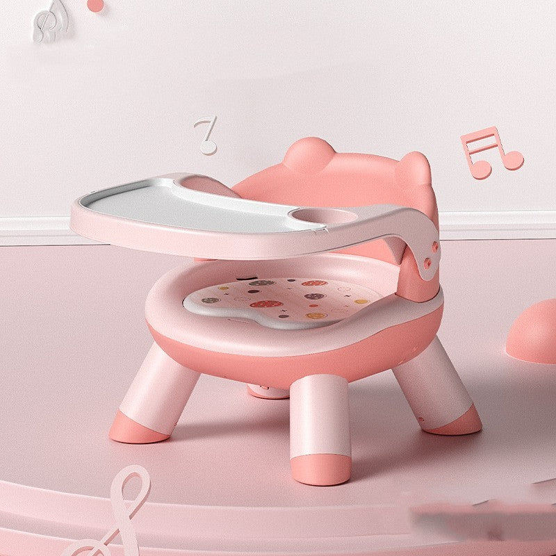 Pink and white children's chair with a tray on a light pink background