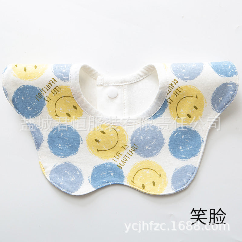 Baby bib with smiley face pattern on a white background